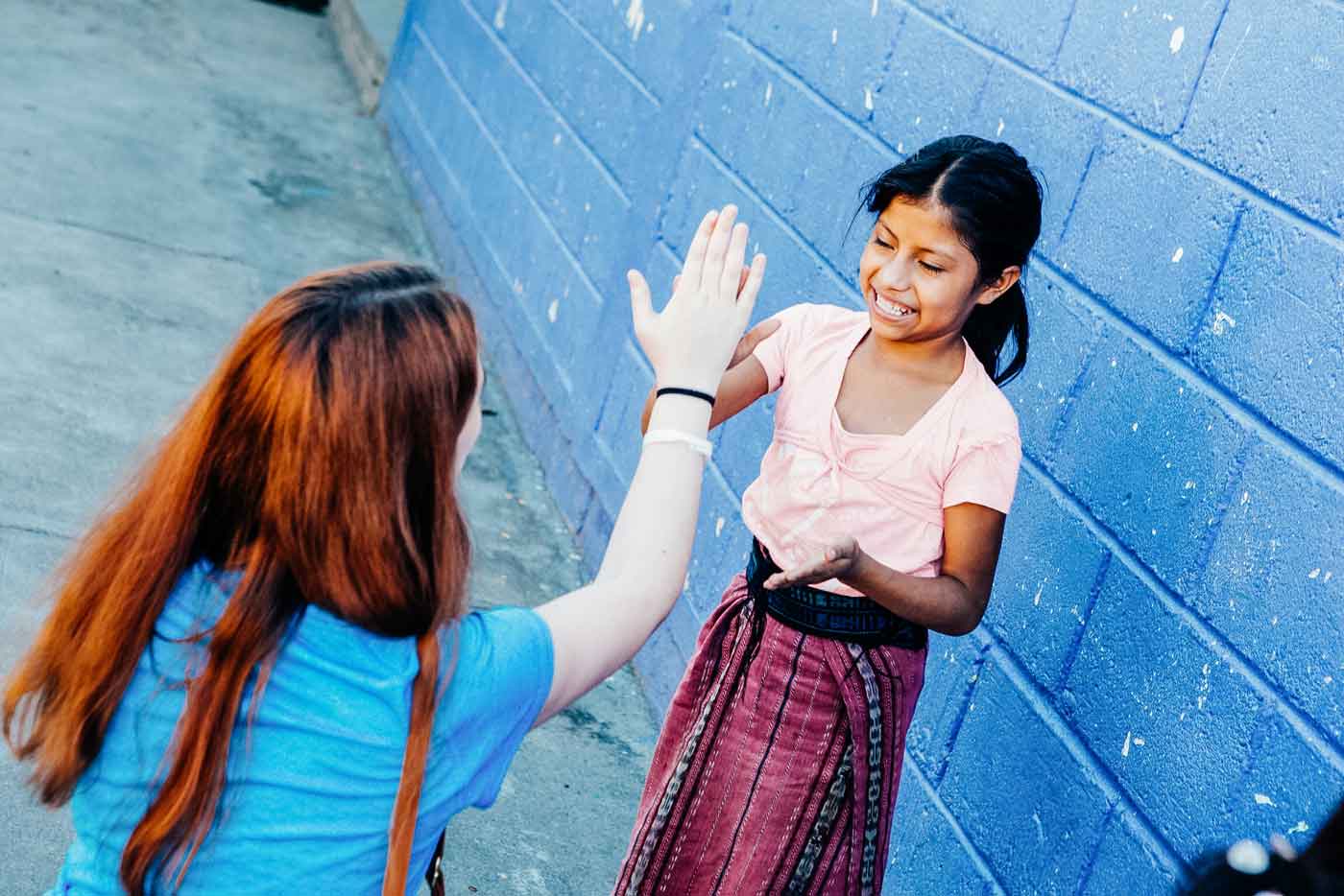 FSM student Mya Ray plays a game with one of the girls at the elementary school