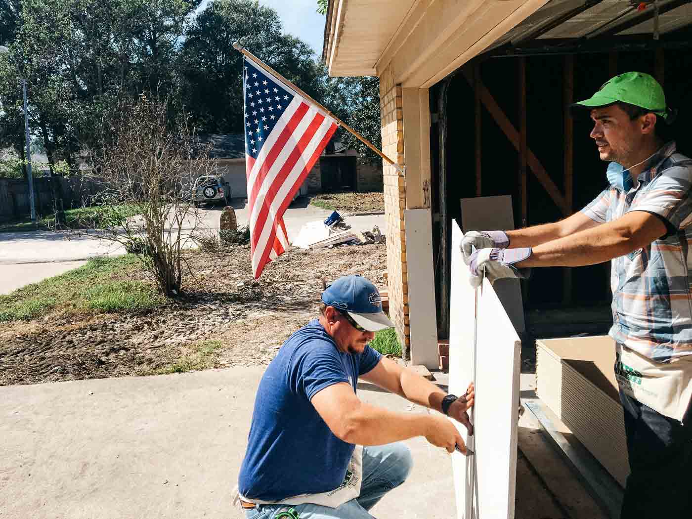 James and David measuring sheetrock